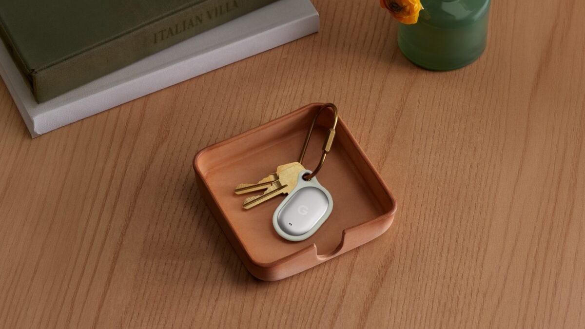 Official Google product photograph of a silver Google Pixel Tag attached to a keyring and resting in a small tray with keys.