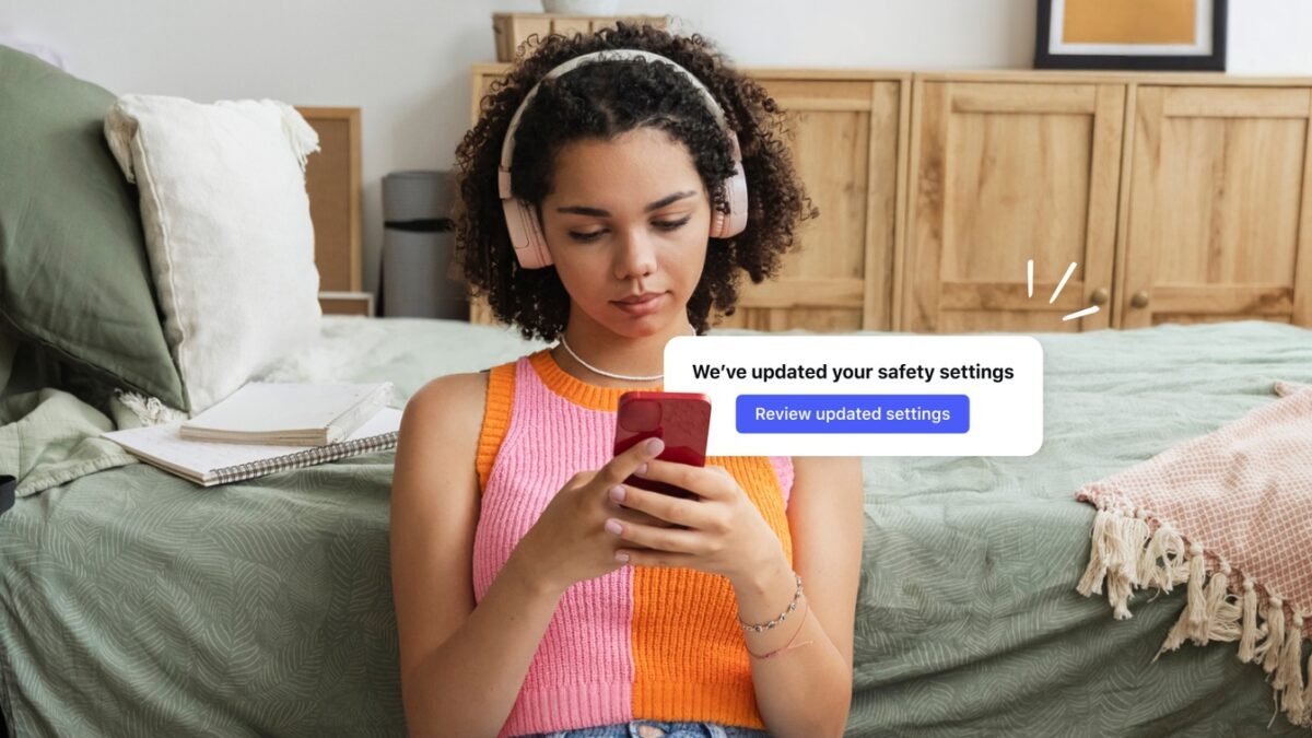 Official Meta teen-safety image: a young person holding a phone with a safety-settings notice, from Meta’s May 2026 age-assurance announcement. Contextual only; it does not depict the New Mexico court proceeding.